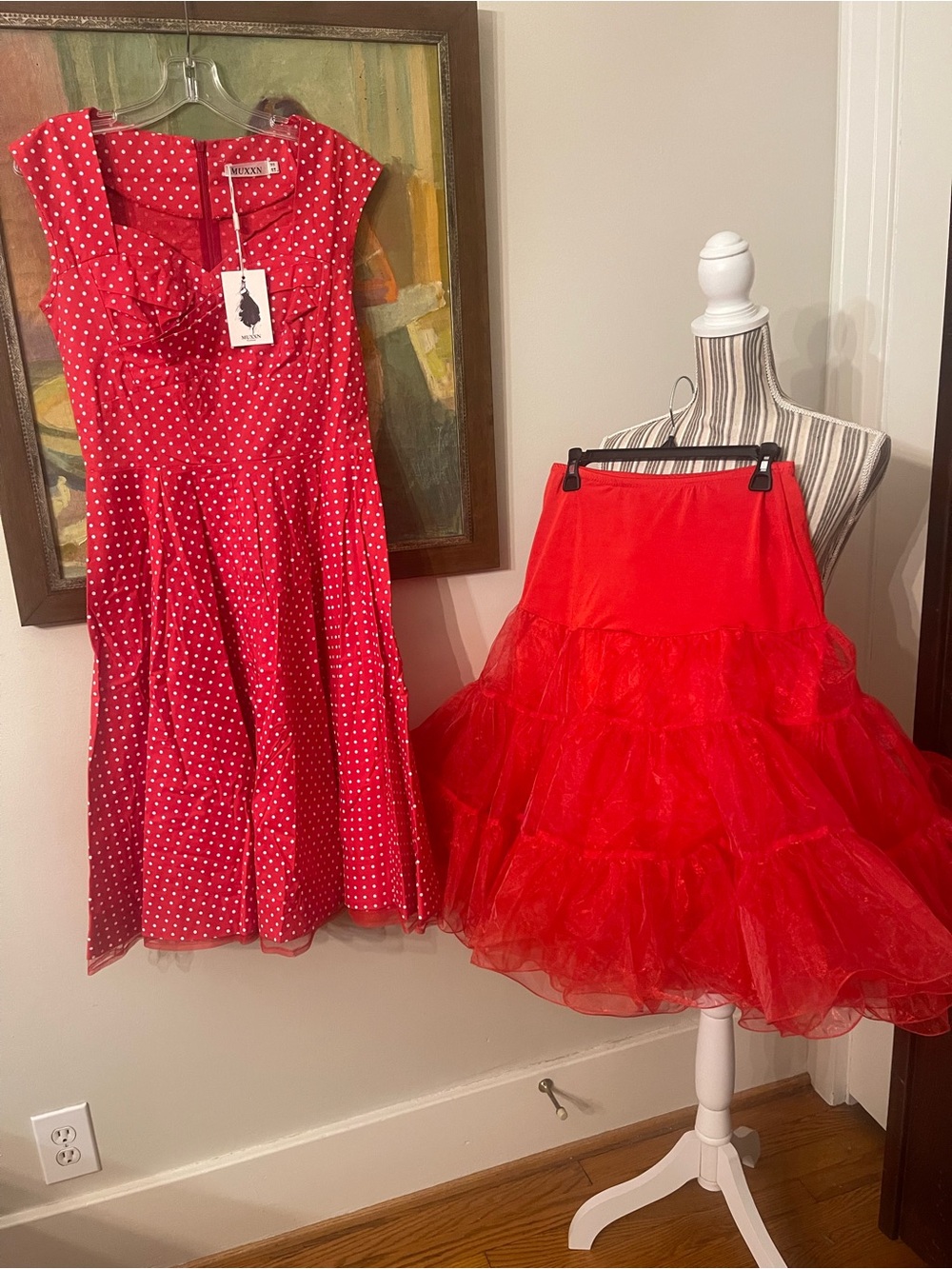Red Polka Dot Midi Dress with Ruched Neckline accompanied by a petticoat